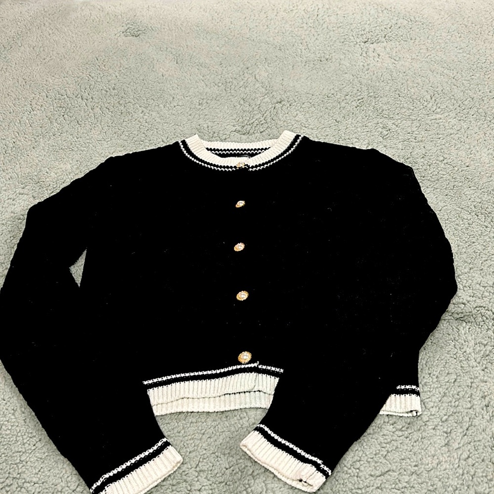 Black and white cardigan with pearl buttons.  Excellent condition. Size small